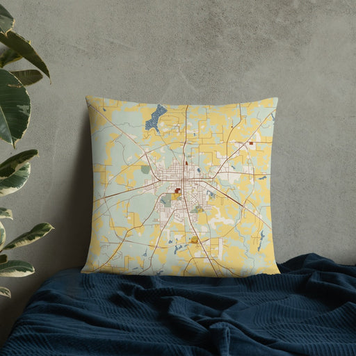 Custom Athens Texas Map Throw Pillow in Woodblock on Bedding Against Wall