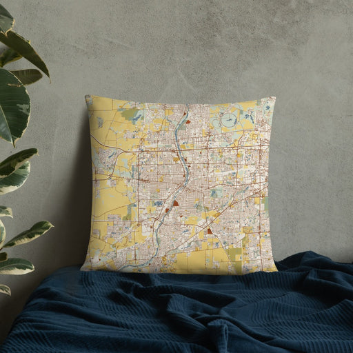 Custom Aurora Illinois Map Throw Pillow in Woodblock on Bedding Against Wall