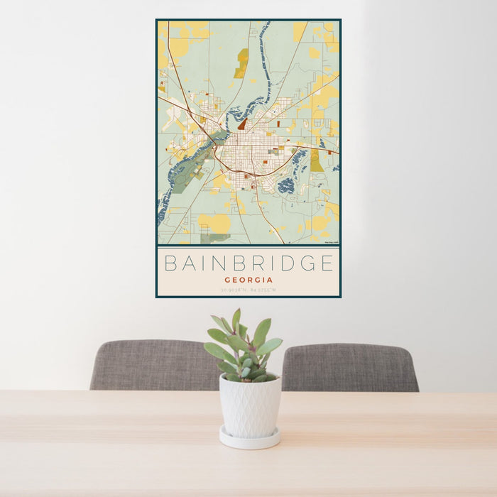 24x36 Bainbridge Georgia Map Print Portrait Orientation in Woodblock Style Behind 2 Chairs Table and Potted Plant