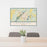 24x36 Bainbridge Georgia Map Print Landscape Orientation in Woodblock Style Behind 2 Chairs Table and Potted Plant