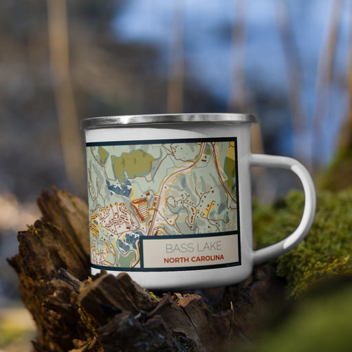 Right View Custom Bass Lake North Carolina Map Enamel Mug in Woodblock on Grass With Trees in Background