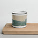 Front View Custom Bay Harbor Michigan Map Enamel Mug in Afternoon on Cutting Board