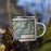 Right View Custom Beartooth Mountains Montana Map Enamel Mug in Woodblock on Grass With Trees in Background