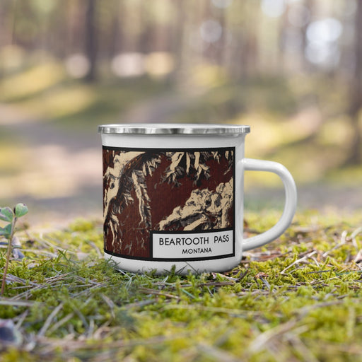 Right View Custom Beartooth Pass Montana Map Enamel Mug in Ember on Grass With Trees in Background