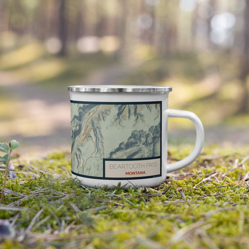 Right View Custom Beartooth Pass Montana Map Enamel Mug in Woodblock on Grass With Trees in Background