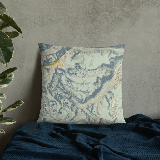Custom Beartooth Pass Montana Map Throw Pillow in Woodblock on Bedding Against Wall