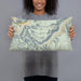 Person holding 20x12 Custom Beartooth Pass Montana Map Throw Pillow in Woodblock