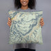 Person holding 18x18 Custom Beartooth Pass Montana Map Throw Pillow in Woodblock