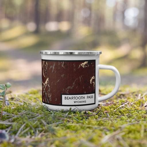 Right View Custom Beartooth Pass Wyoming Map Enamel Mug in Ember on Grass With Trees in Background
