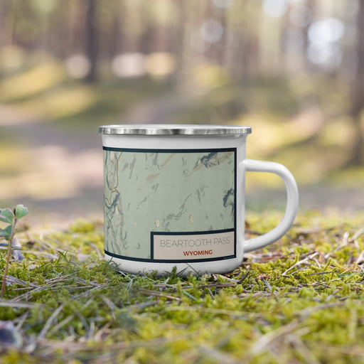 Right View Custom Beartooth Pass Wyoming Map Enamel Mug in Woodblock on Grass With Trees in Background