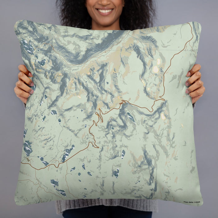 Person holding 22x22 Custom Beartooth Pass Wyoming Map Throw Pillow in Woodblock