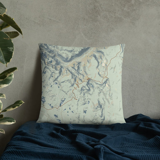 Custom Beartooth Pass Wyoming Map Throw Pillow in Woodblock on Bedding Against Wall