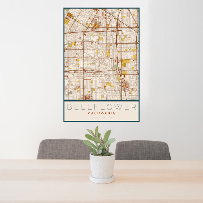 24x36 Bellflower California Map Print Portrait Orientation in Woodblock Style Behind 2 Chairs Table and Potted Plant