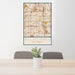 24x36 Bellflower California Map Print Portrait Orientation in Woodblock Style Behind 2 Chairs Table and Potted Plant