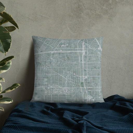 Custom Bellflower California Map Throw Pillow in Afternoon on Bedding Against Wall