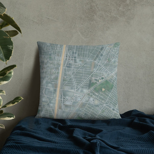 Custom Bell Gardens California Map Throw Pillow in Afternoon on Bedding Against Wall