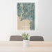 24x36 Bigfork Montana Map Print Portrait Orientation in Afternoon Style Behind 2 Chairs Table and Potted Plant