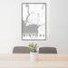 24x36 Bigfork Montana Map Print Portrait Orientation in Classic Style Behind 2 Chairs Table and Potted Plant