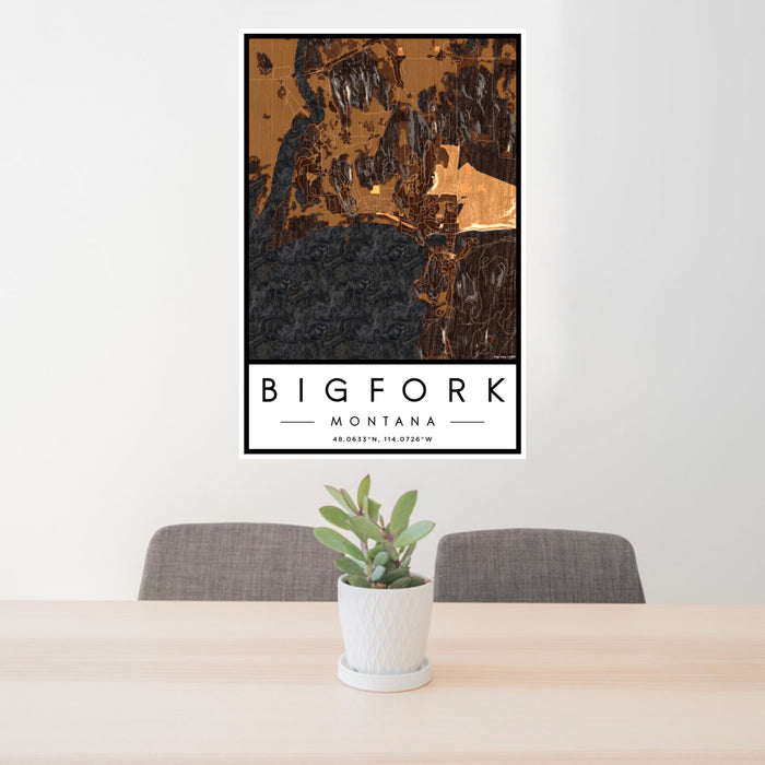 24x36 Bigfork Montana Map Print Portrait Orientation in Ember Style Behind 2 Chairs Table and Potted Plant