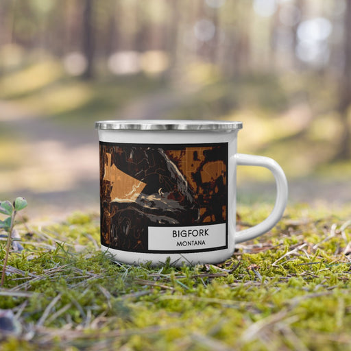 Right View Custom Bigfork Montana Map Enamel Mug in Ember on Grass With Trees in Background