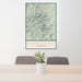 24x36 Bighorn Mountains Wyoming Map Print Portrait Orientation in Woodblock Style Behind 2 Chairs Table and Potted Plant