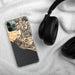 Custom Big Sur California Map Phone Case in Ember on Table with Black Headphones