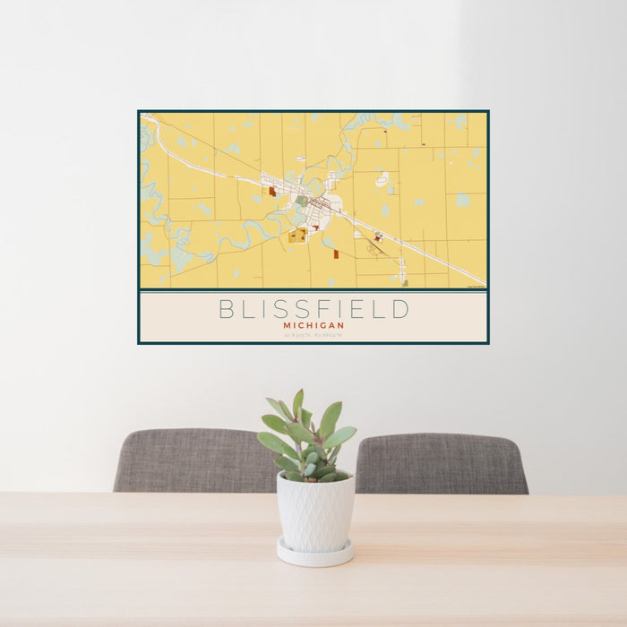 24x36 Blissfield Michigan Map Print Landscape Orientation in Woodblock Style Behind 2 Chairs Table and Potted Plant