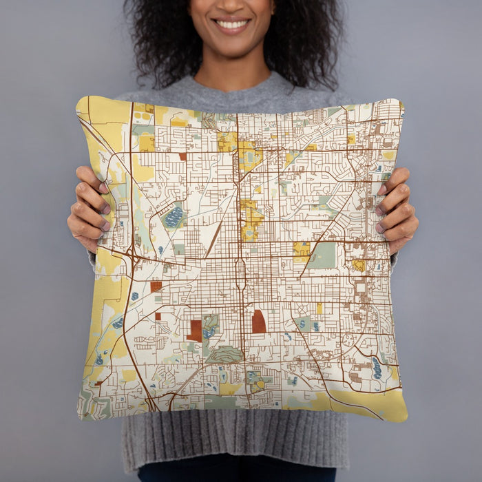 Person holding 18x18 Custom Bloomington Illinois Map Throw Pillow in Woodblock