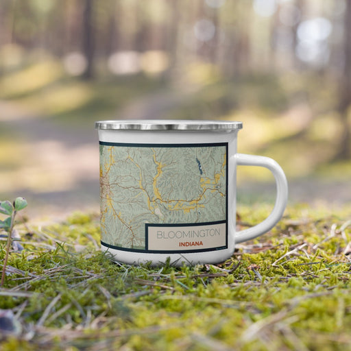 Right View Custom Bloomington Indiana Map Enamel Mug in Woodblock on Grass With Trees in Background