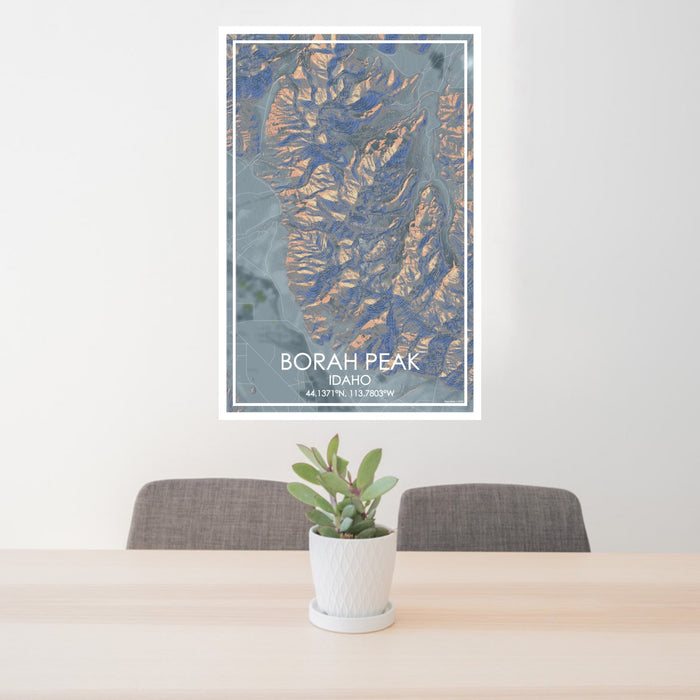 24x36 Borah Peak Idaho Map Print Portrait Orientation in Afternoon Style Behind 2 Chairs Table and Potted Plant