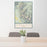 24x36 Borah Peak Idaho Map Print Portrait Orientation in Woodblock Style Behind 2 Chairs Table and Potted Plant