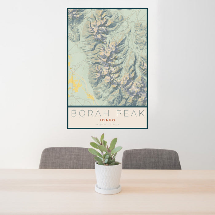 24x36 Borah Peak Idaho Map Print Portrait Orientation in Woodblock Style Behind 2 Chairs Table and Potted Plant