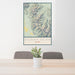 24x36 Borah Peak Idaho Map Print Portrait Orientation in Woodblock Style Behind 2 Chairs Table and Potted Plant