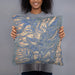 Person holding 18x18 Custom Borah Peak Idaho Map Throw Pillow in Afternoon
