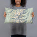 Person holding 20x12 Custom Borah Peak Idaho Map Throw Pillow in Woodblock