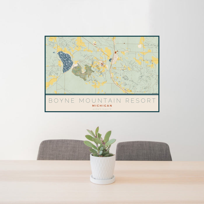 24x36 Boyne Mountain Resort Michigan Map Print Lanscape Orientation in Woodblock Style Behind 2 Chairs Table and Potted Plant