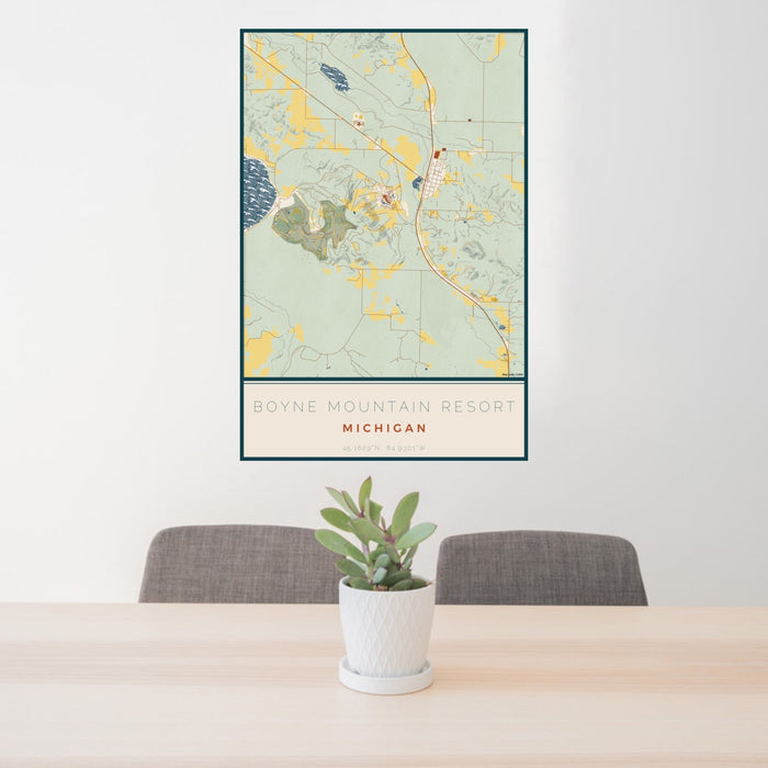 24x36 Boyne Mountain Resort Michigan Map Print Portrait Orientation in Woodblock Style Behind 2 Chairs Table and Potted Plant