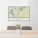 24x36 Brainerd Minnesota Map Print Lanscape Orientation in Woodblock Style Behind 2 Chairs Table and Potted Plant