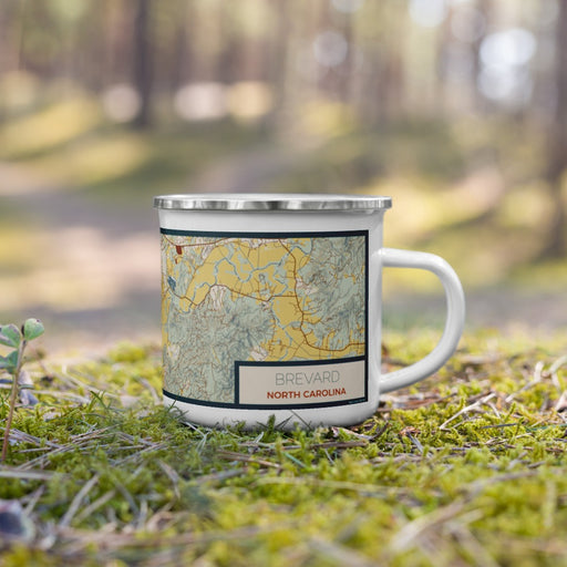 Right View Custom Brevard North Carolina Map Enamel Mug in Woodblock on Grass With Trees in Background