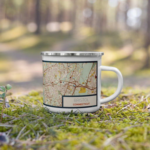 Right View Custom Bristol Connecticut Map Enamel Mug in Woodblock on Grass With Trees in Background