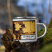 Right View Custom Browns Lake Wisconsin Map Enamel Mug in Ember on Grass With Trees in Background
