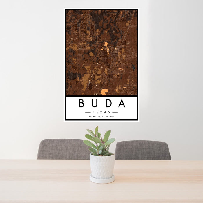 24x36 Buda Texas Map Print Portrait Orientation in Ember Style Behind 2 Chairs Table and Potted Plant
