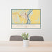 24x36 Burlington Iowa Map Print Landscape Orientation in Woodblock Style Behind 2 Chairs Table and Potted Plant