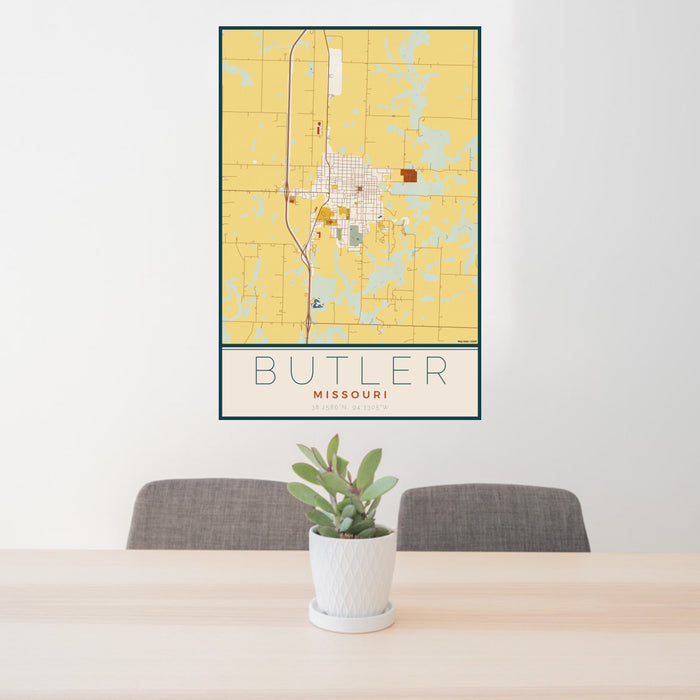 24x36 Butler Missouri Map Print Portrait Orientation in Woodblock Style Behind 2 Chairs Table and Potted Plant