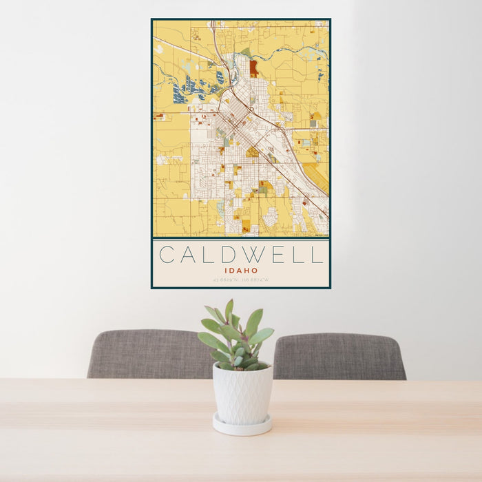24x36 Caldwell Idaho Map Print Portrait Orientation in Woodblock Style Behind 2 Chairs Table and Potted Plant