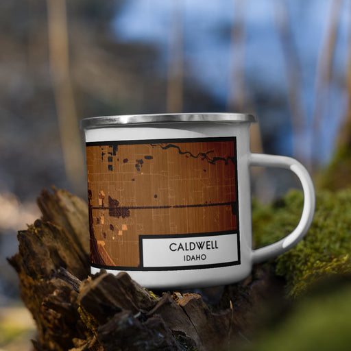 Right View Custom Caldwell Idaho Map Enamel Mug in Ember on Grass With Trees in Background