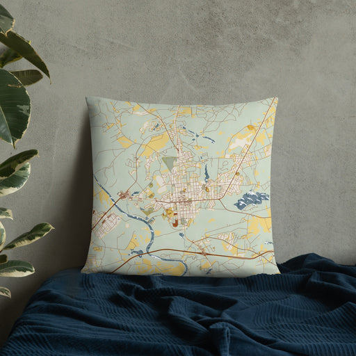 Custom Camden South Carolina Map Throw Pillow in Woodblock on Bedding Against Wall