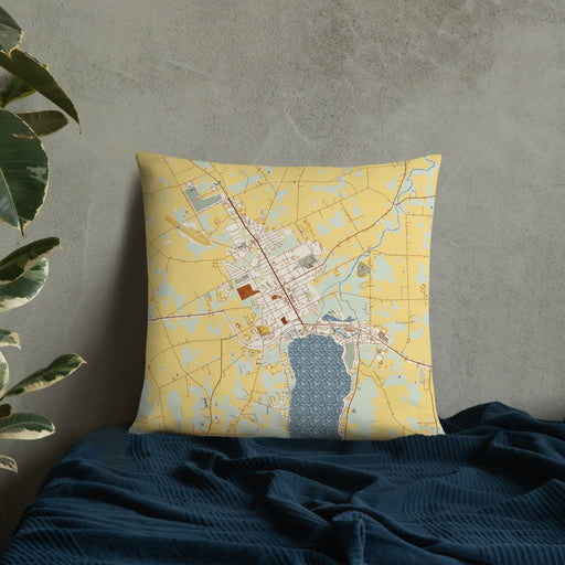 Custom Canandaigua New York Map Throw Pillow in Woodblock on Bedding Against Wall