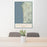 24x36 Cannon Beach Oregon Map Print Portrait Orientation in Woodblock Style Behind 2 Chairs Table and Potted Plant