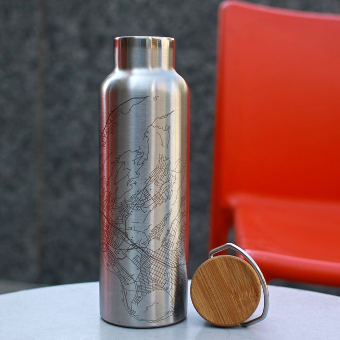 20oz Stainless Steel Insulated Bottle with Bamboo Top with Custom Engraving of Map on White Table and Red Chair